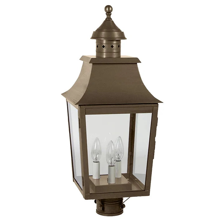 Bronze outdoor lantern with clear glass on a gray background