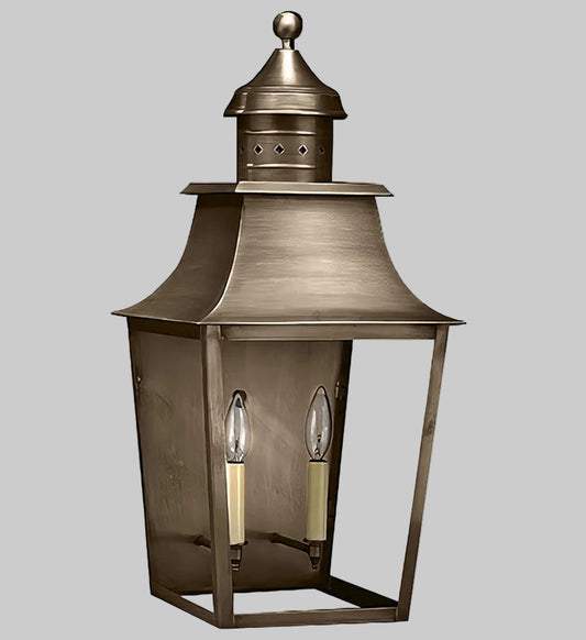 Bronze outdoor lantern with two light bulbs on a gray background