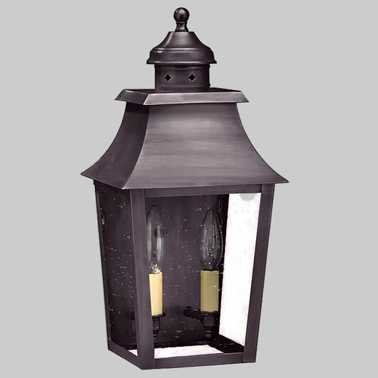 Decorative outdoor lantern with a dark finish on a gray background