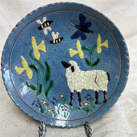 Vibrant blue redware plate with sheep, flowers, bee and butterfly motif