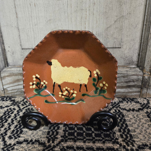 Octagonal redware plate with a sheep and flowers motif