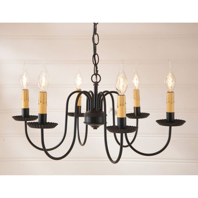 Black chandelier with six candle-style lights on a beige background