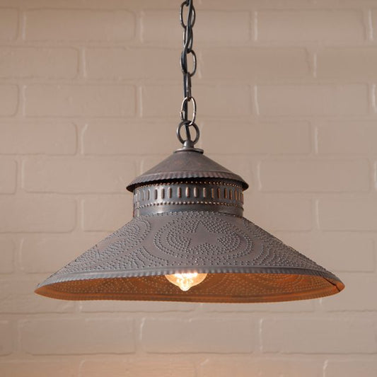 Vintage-style pendant light with textured shade against a brick wall background