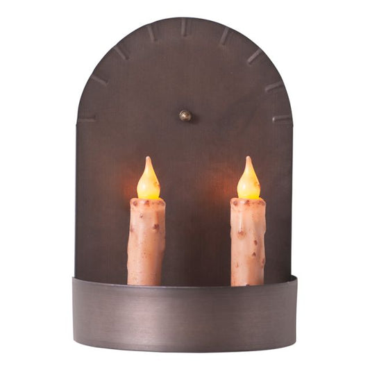 Tin candle sconce holding two battery operated tapers on white background