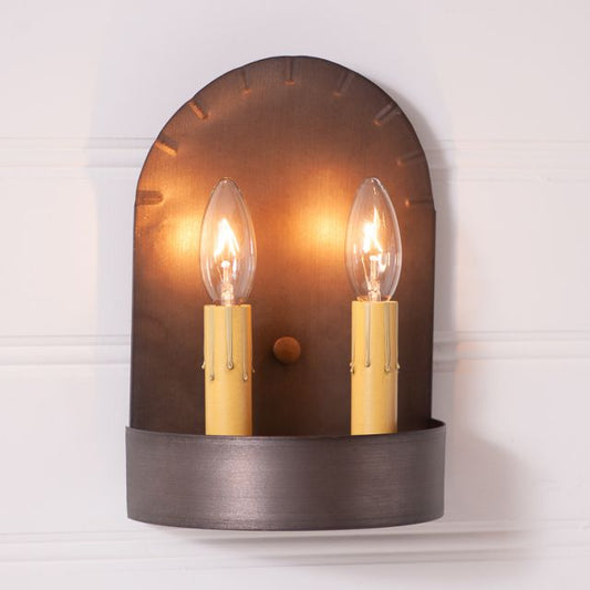 Short two light tin sconce that has two candelabra sockets on white background