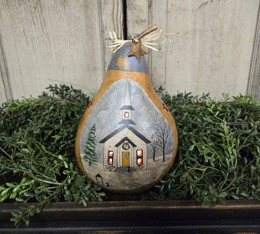 A hand-painted lighted gourd featuring a rural church scene with a warm-toned house and a clear night sky.
