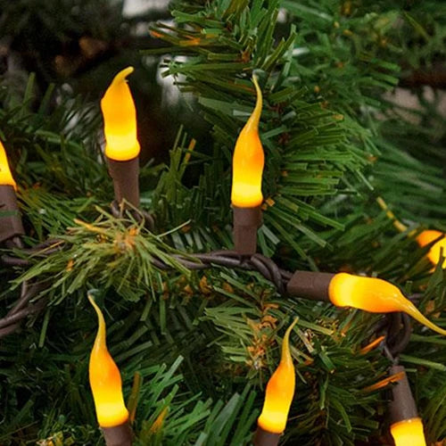 String lights with yellow silicone bulbs on a brown cord, displayed on a green Christmas tree.
