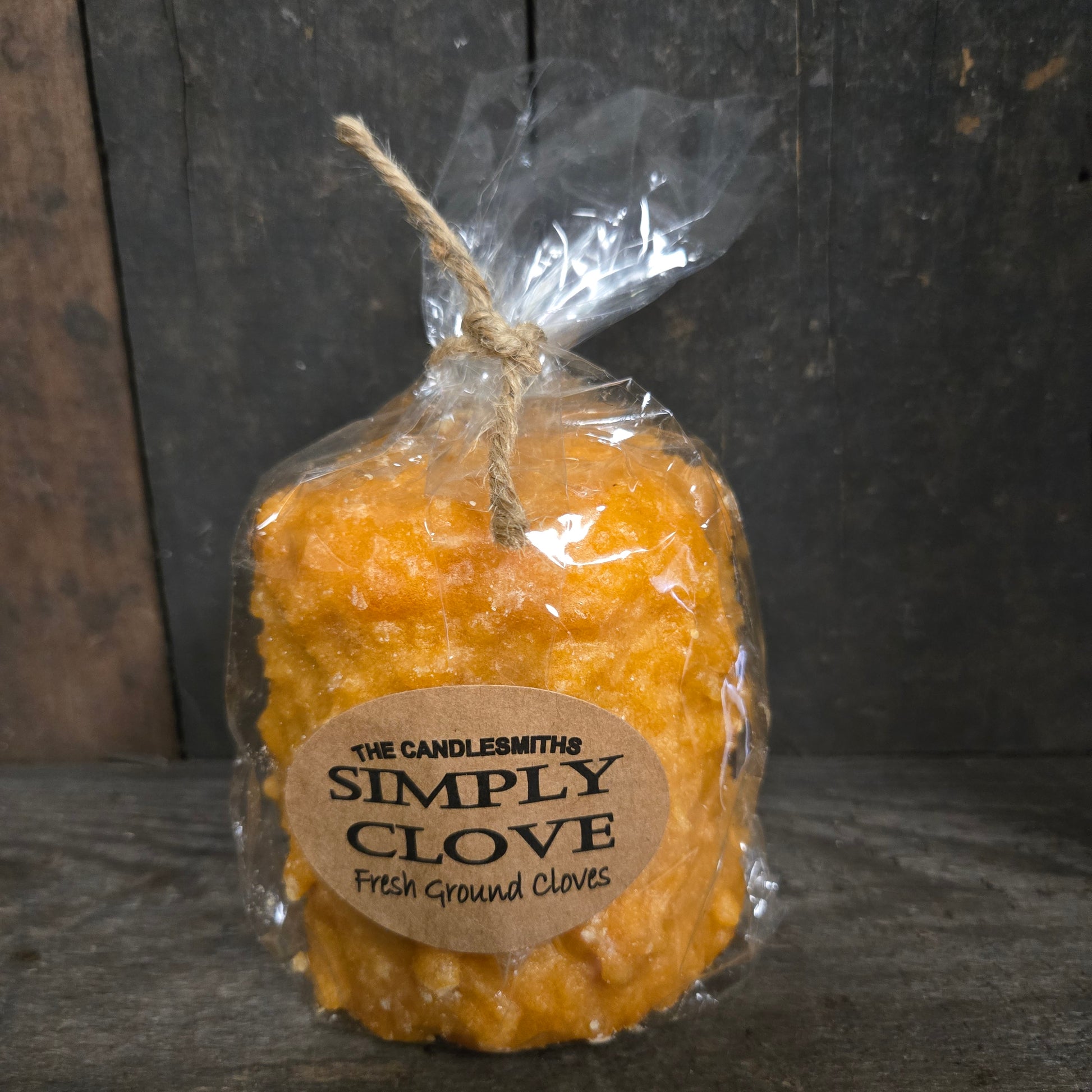 Packaged yellow product with a label on a dark wooden surface