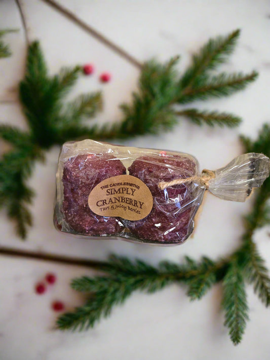Two red cranberry votive candles packaged together with a label showing the brand and product name.