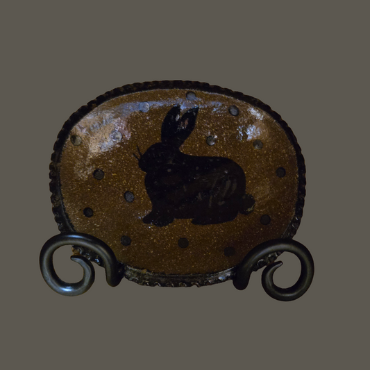 Small oval stoneware plate with blue glazing featuring a sitting bunny and polka dot motif