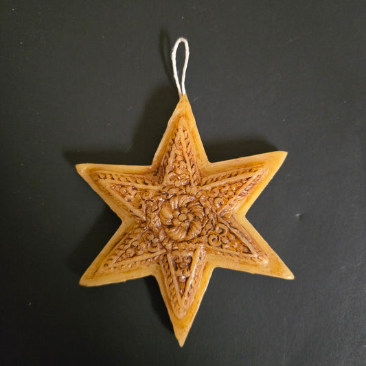 Decorative star ornament with intricate patterns on a black background