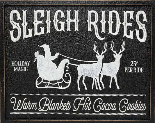 Decorative sign with 'Sleigh Rides' text and reindeer illustration on a metal background