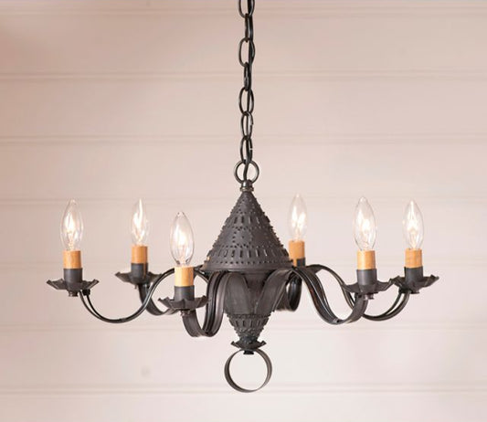 Black wrought iron chandelier with six candles on a beige background