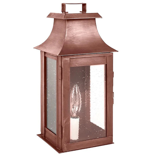 Copper lantern with a clear glass cover on a white background
