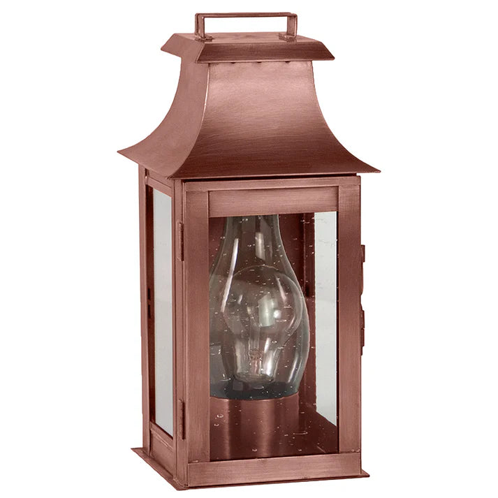 Copper lantern with clear glass shade on a white background