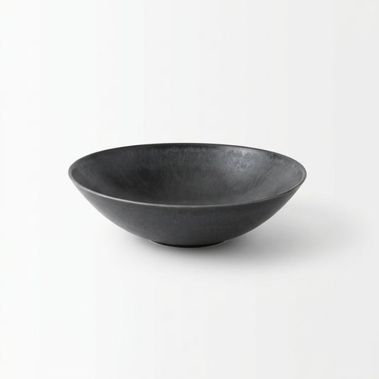 Black bowl on a textured on a white background.