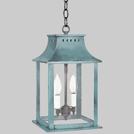 Blue hanging lantern with a white candle on a white background