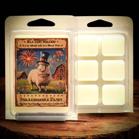 Wax tart melt package with a sheep and barn design on a wooden surface