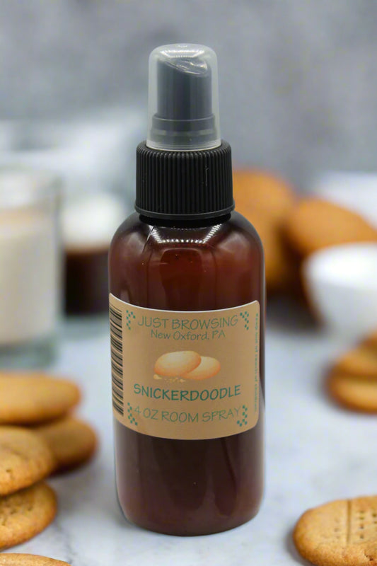 Brown spray bottle with a label on a gray background with cookies around it