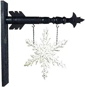 A black arrow-shaped snowflake arrow replacement with a decorative snowflake design hanging from it.