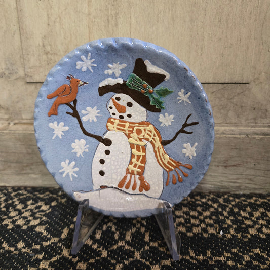 Vibrant blue redware plate featuring a snowman with a cardinal perched on his twig arm
