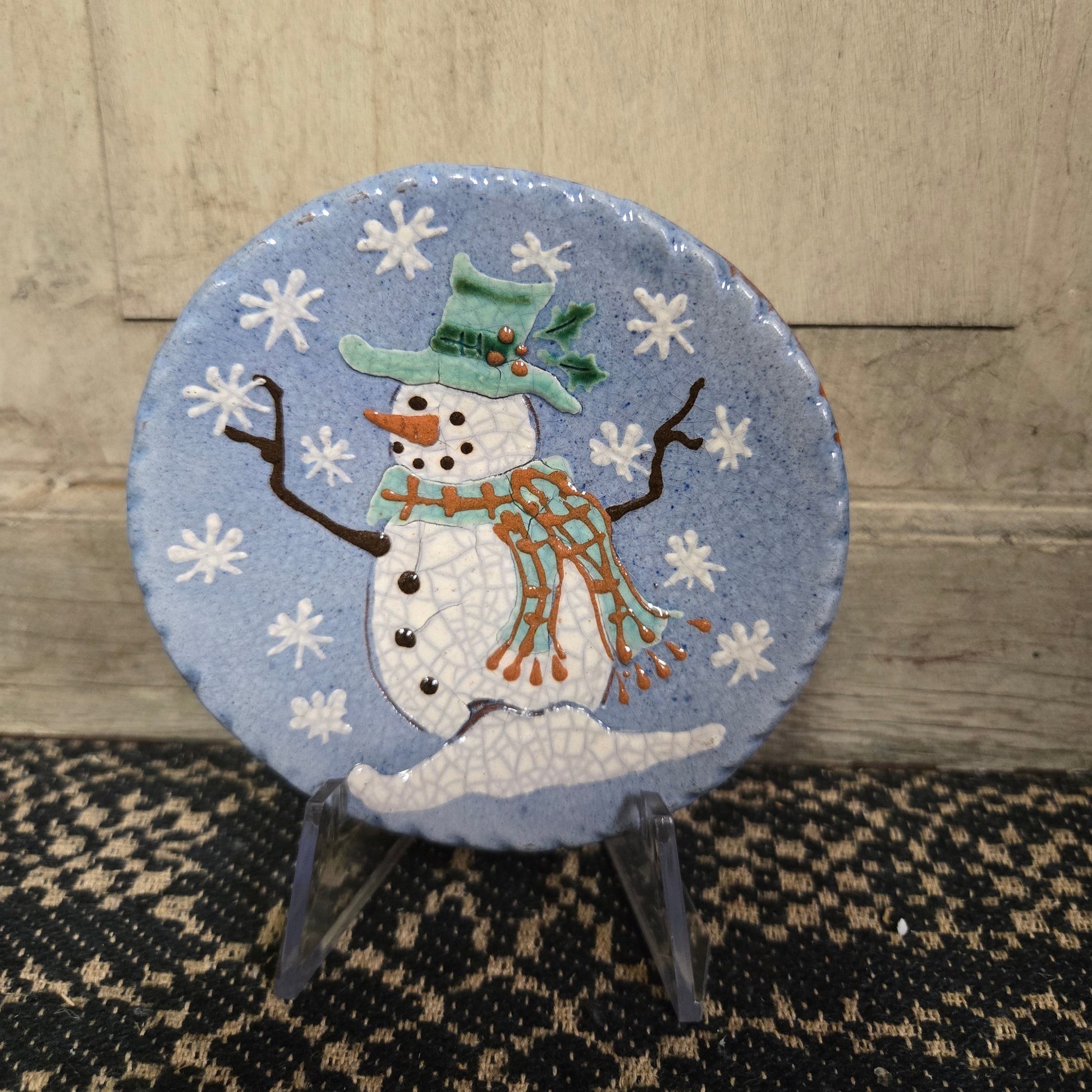 A 4-inch diameter handcrafted ceramic plate with a snowman design, titled 'Turtle Creek Pottery' from David T. Smith workshops.