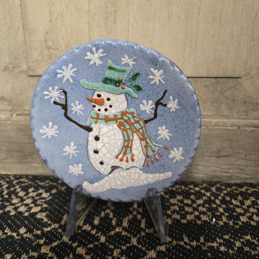 A 4-inch diameter handcrafted ceramic plate with a snowman design, titled 'Turtle Creek Pottery' from David T. Smith workshops.