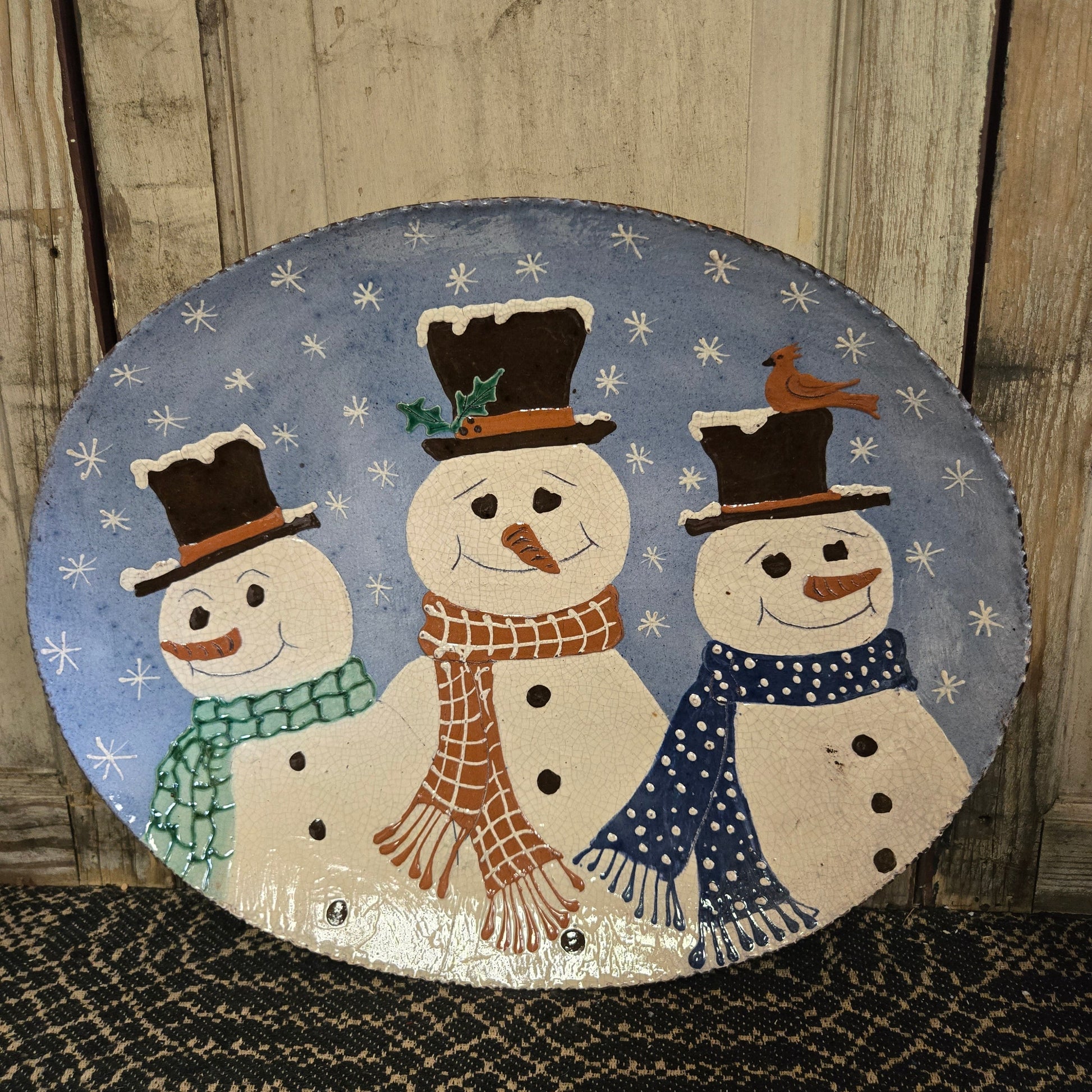 16" oval redware plate with three snowmen
