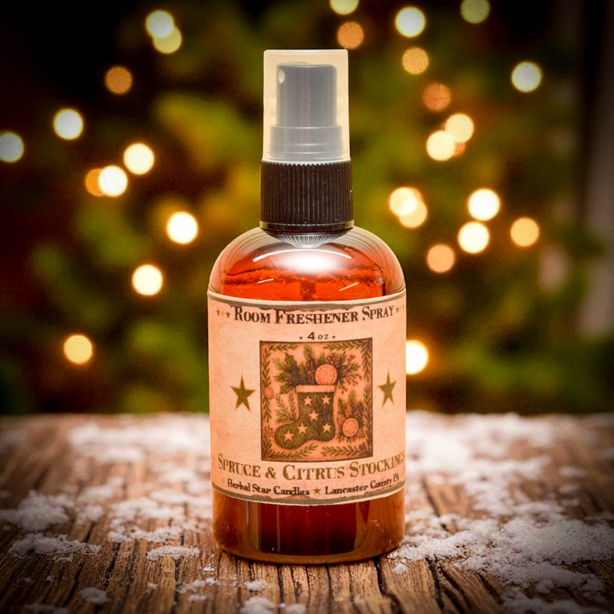 Room freshener spray bottle with decorative label on a wooden surface with a festive background.