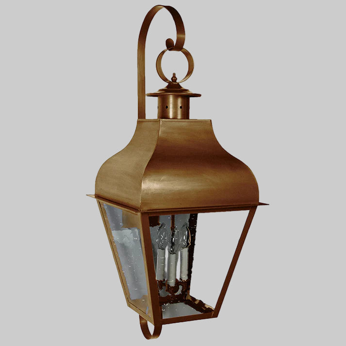 Bronze outdoor wall lantern with clear glass on a white background