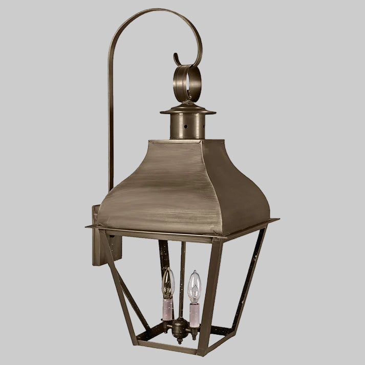 Bronze outdoor lantern with two visible light bulbs on a white background