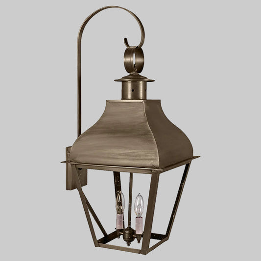 Bronze outdoor lantern with two visible light bulbs on a white background