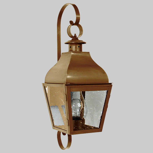 Bronze outdoor wall lantern with clear glass on a white background