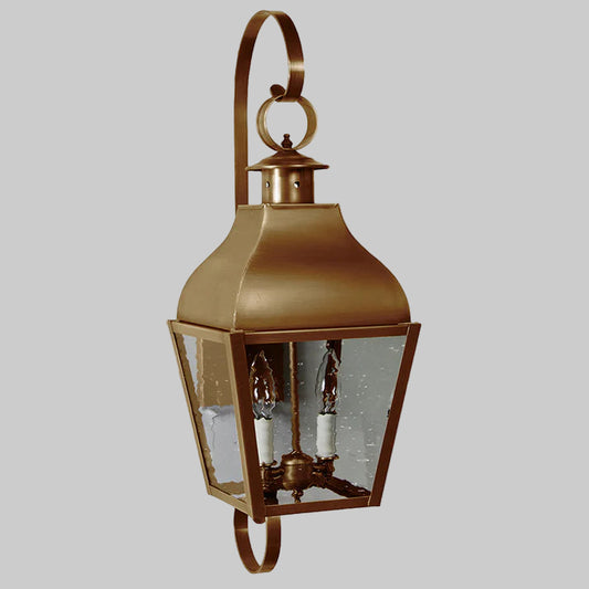 Bronze outdoor wall lantern with glass panels on a white background