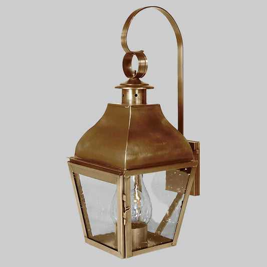 Bronze outdoor wall lantern with clear glass on a white background