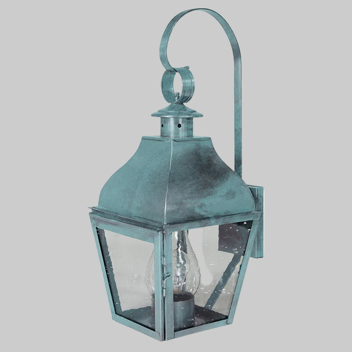 Vintage-style teal wall lantern with glass cover on a white background