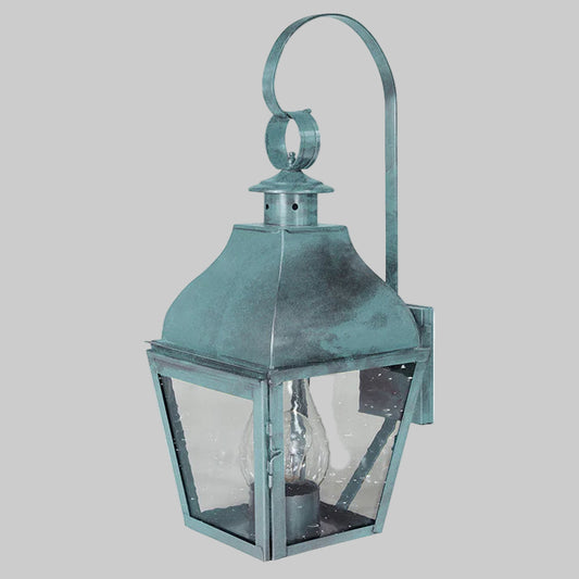 Vintage-style teal wall lantern with glass cover on a white background