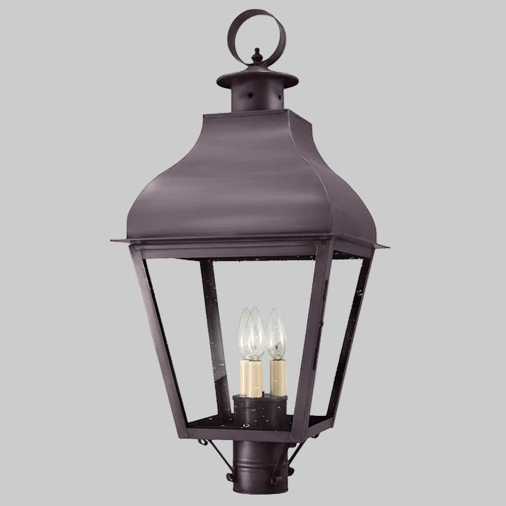 Dark metal outdoor lantern with two visible light bulbs on a gray background