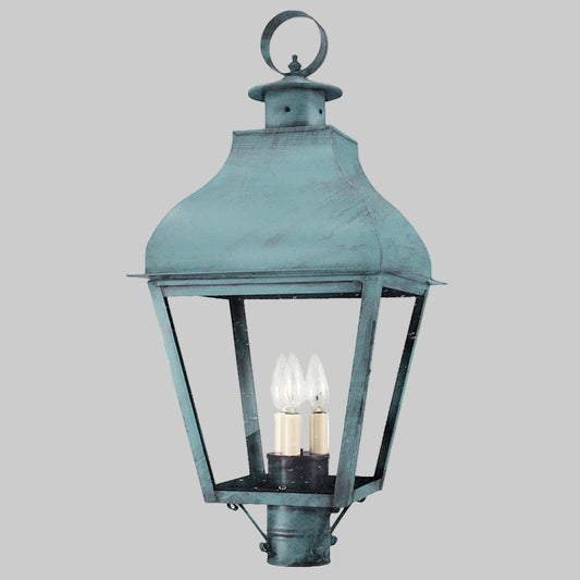 Vintage-style outdoor lamp with a greenish-blue finish on a gray background