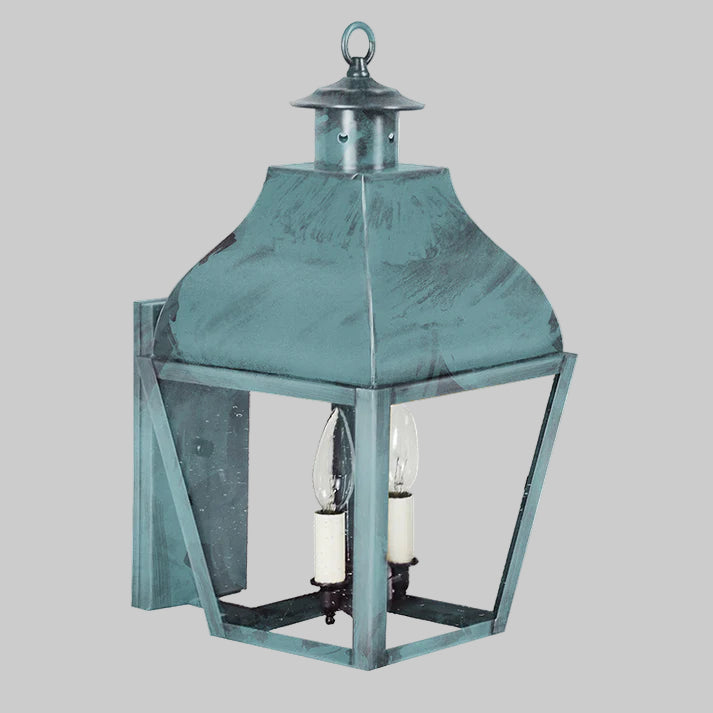 Decorative outdoor lantern with a metallic finish on a gray background