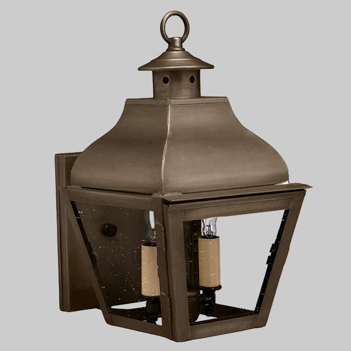 Bronze outdoor wall lantern on a gray background