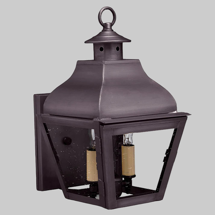 Decorative outdoor lantern with two candle holders on a gray background