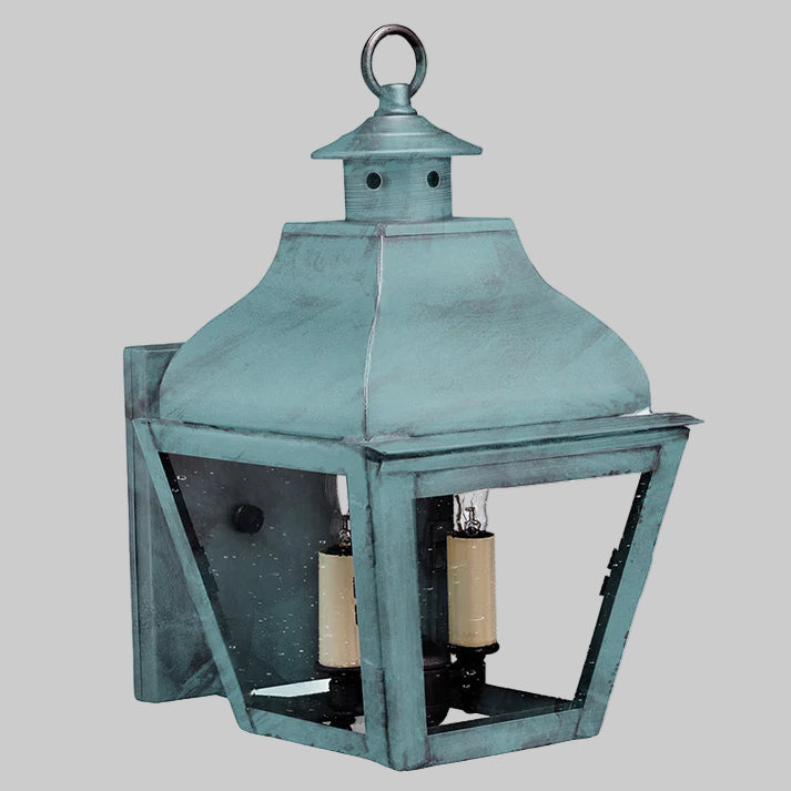 Vintage-style teal lantern with clear glass on a gray background