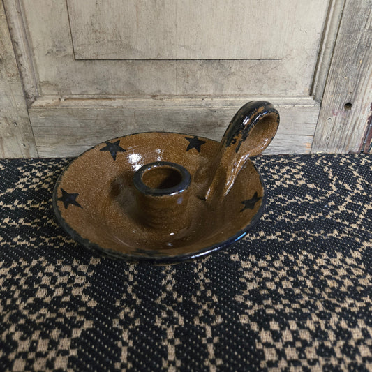 Brown stoneware candle holder with blue glazed star accents