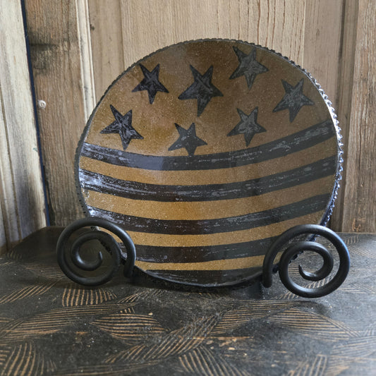 Decorative stoneware plate with stars ands stripes pattern on a wooden background