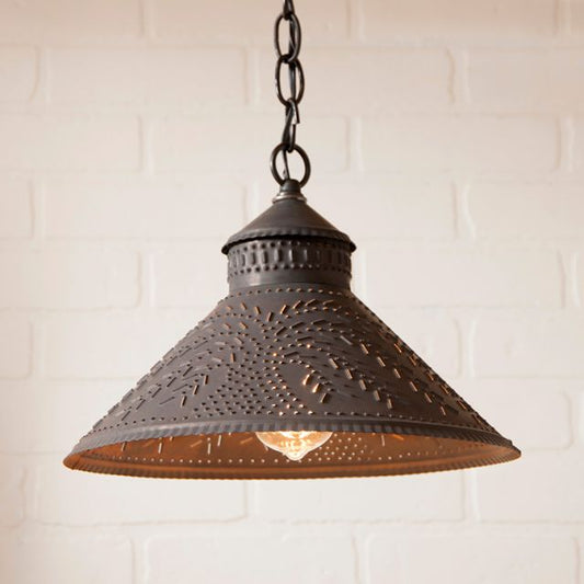 Decorative pendant light with intricate design on a white brick wall background