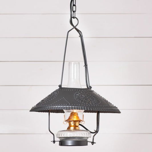 Vintage-style pendant light with dark metal shade and clear glass cover on a white wooden background