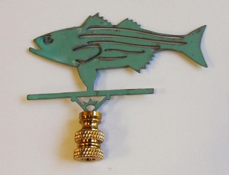 A verdigris lamp finial in the shape of a fish with a gold-colored top.