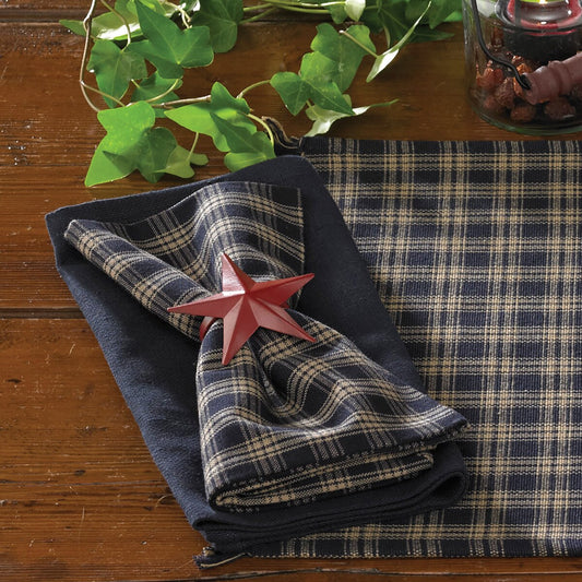 Plaid napkin with a red star on a wooden table