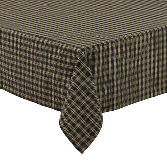 A black checkered tablecloth on a table, with a neatly folded napkin at the center.